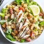 Recipe card for low-calorie chicken Caesar pasta salad with ingredients, instructions, and nutrition details.
